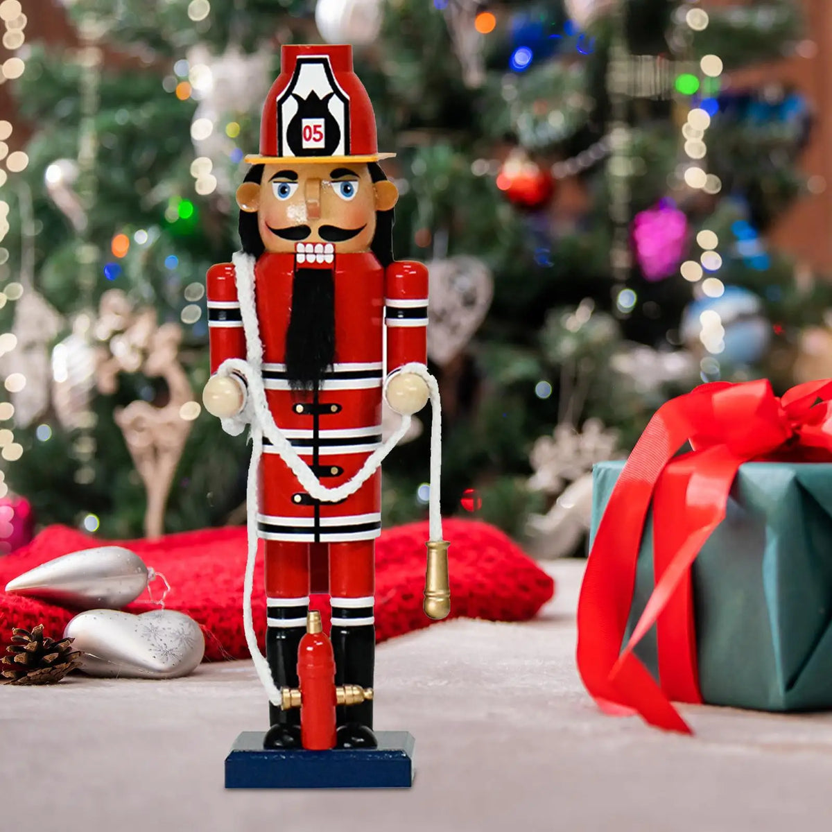 Firefighter nutcracker displayed beside Christmas gifts and tree decorations