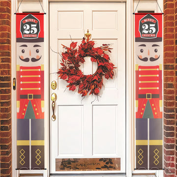 Decorative Christmas nutcracker banners on a door with a wreath.